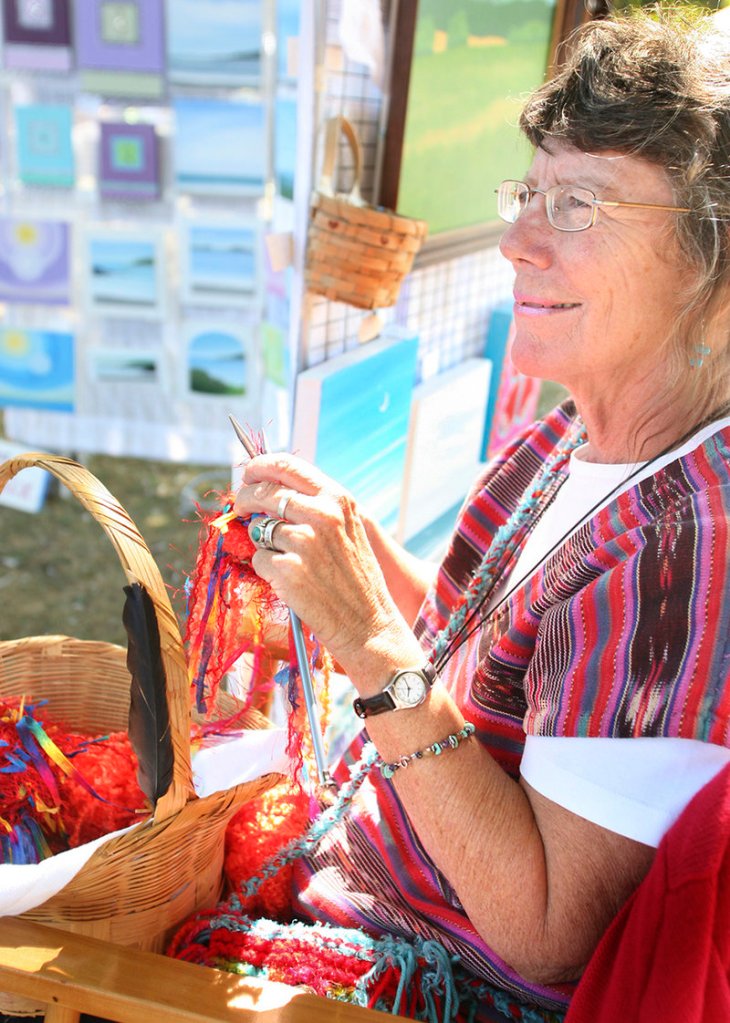 Nancy Clark of Turner knits one of her fancy bags at her booth.