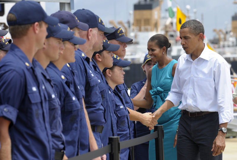 President Obama and first lady Michelle Obama greet members of the Coast Guard on Saturday while visiting the Guard’s district office in Panama City, Fla.