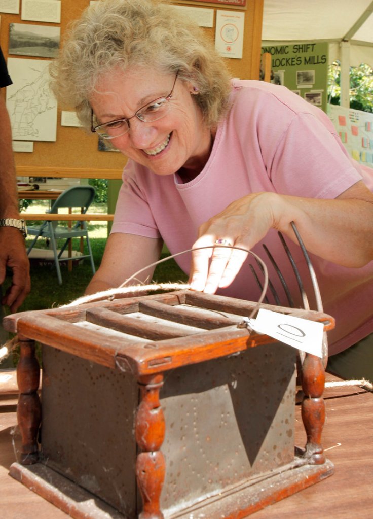 Faye Russell of Mason Township guesses about a historic item in the What's It Contest at the Summer Heritage Festival.