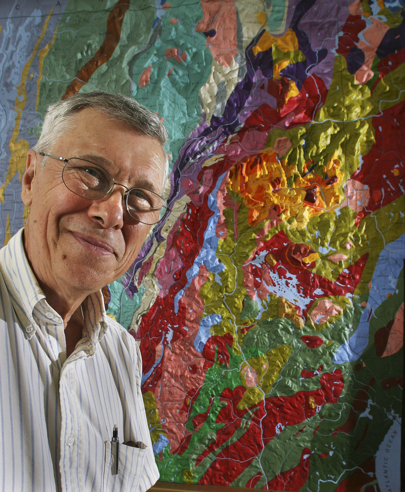 University of New Hampshire geology professor Wally Bothner poses in front of a relief map at the university in Durham. Bothner and a team of UNH students spent the last year repairing and repainting the 12- by 16-foot wood and plaster map created in the late 1800s by Charles Hitchcock, one of New Hampshire’s first state geologists.