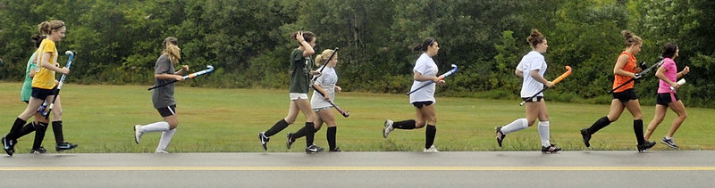 Biddeford field hockey players go for a run with their new coach, Leslie Mourmouras, leading the way. Mourmouras also coaches track and field and previously was Biddeford’s cross country coach.