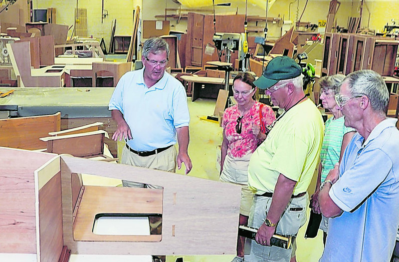 Bentley Collins, left, vice president of marketing and sales at Sabre Yachts in Raymond, explains the company’s processes to a tour group Tuesday. The group includes, left to right, Ginnie and Chuck Hurley, both from Annapolis, Md., and Joyce and Richard Knight of North Yarmouth.