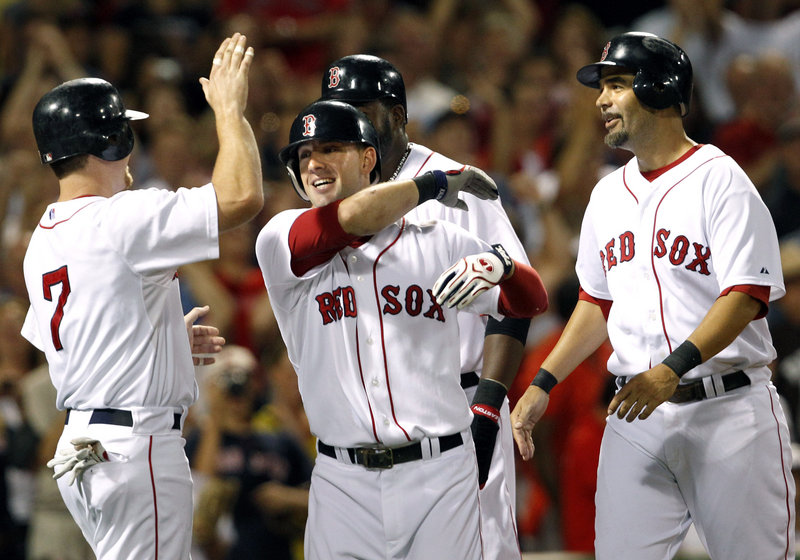 Ryan Kalish, center, celebrates his grand slam with J.D. Drew, left, David Ortiz and Mike Lowell, right, during the fourth inning Tuesday night at Fenway Park.