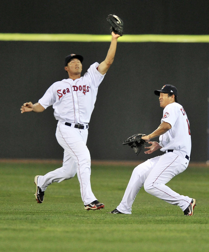 Center fielder Che-Hsuan Lin of the Portland Sea Dogs takes command Tuesday night and pulls in a fly ball in front of right fielder Chih-Hsien Chiang in the fourth inning of a 4-2 loss to the Altoona Curve.