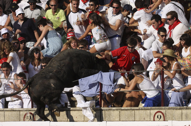 An 1,100-pound bull leaps into the stands during a bullfight in Tafalla, northern Spain, in this photo from Wednesday. Up to 40 were injured and three were hospitalized when the bull cleared two barriers before leaping into the stands. The bull was captured and later killed.