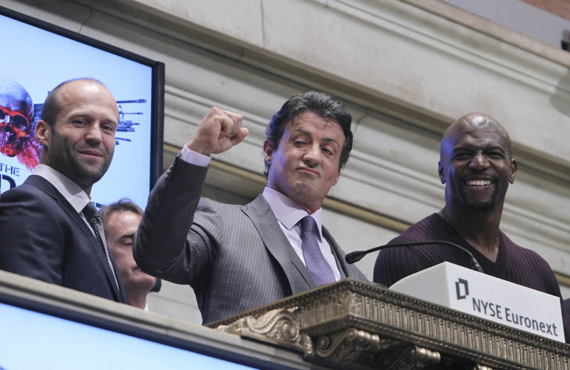 Cast members from the movie “The Expendables” – from left, Jason Statham, Sylvester Stallone and Terry Crews – ring the opening bell Thursday at the New York Stock Exchange in New York City. As the “expendables” in the action thriller that came out last week, they won more than their share of supercharged street brawls. Wall Street, however, could not be tamed. The Dow Jones industrial average fell 144 points.