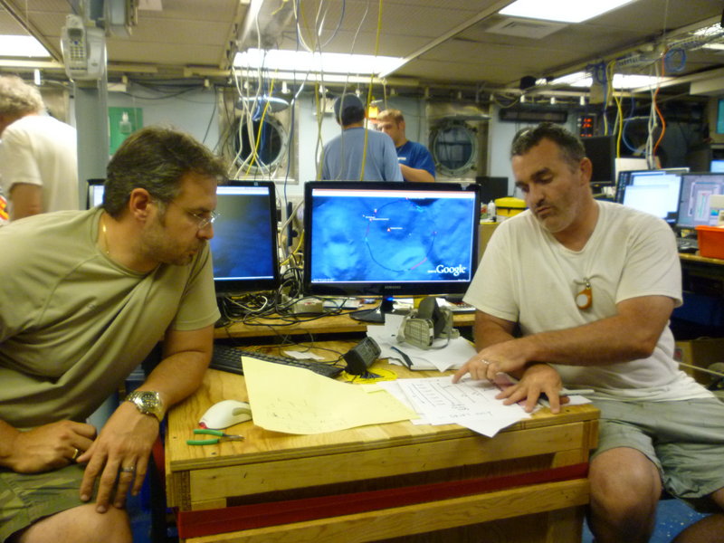 Rich Camilli, left, and Chris Reddy of the Woods Hole Oceanographic Institution discuss oil plume measurements in June aboard the research vessel Endeavor in the Gulf of Mexico. Camilli, chief author of a study released Thursday, said the plume is at least 22 miles long and probably even larger, but scientists had to stop measuring it because of Hurricane Alex.