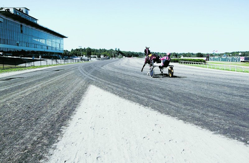 Mark Harris, a horse trainer and owner, jogs his horse, Fast Guy, before the start of live racing at the Scarborough Downs racetrack on Thursday. Scarborough voters have twice rejected proposals that would have allowed slot machines at the harness-racing facility.