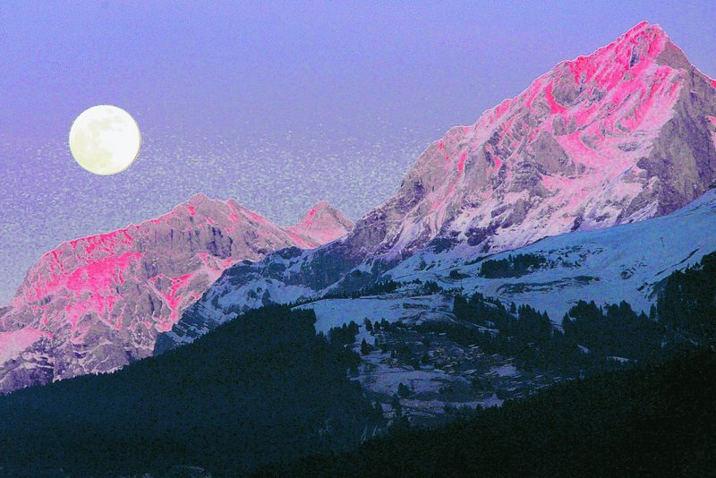 The moon rises above the Swiss alps: Several landforms around the moon suggest that the surface has shrunk as the interior has cooled over time and also shrunk.