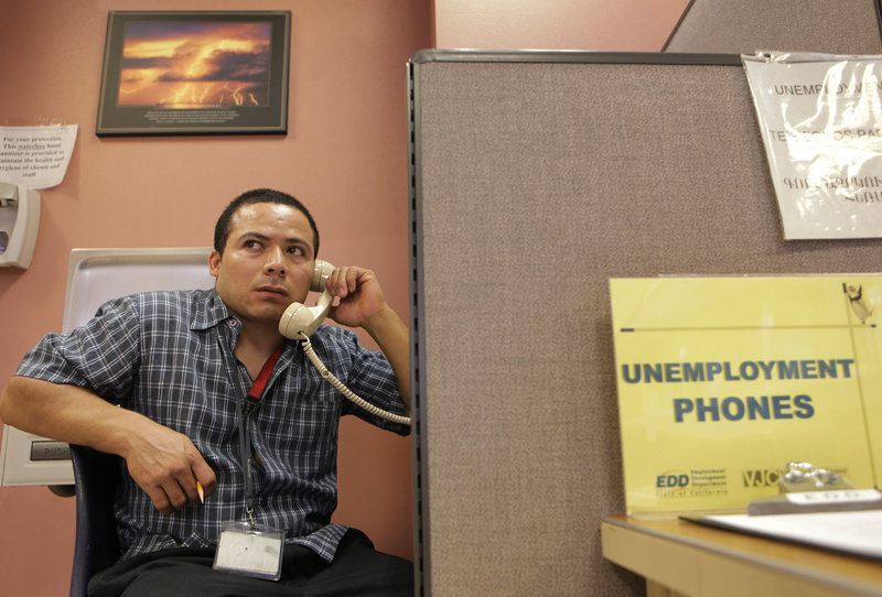 Unemployed mechanic Jaime Rivas calls to request an extension on his jobless benefits Thursday in Glendale, Calif., amid fears that employers are cutting jobs again.