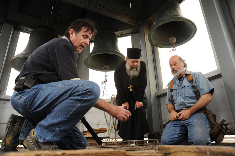 Bob Medinger, director of the Sitka Historical Society, left, Father Sergious Gerken and contractor Pete Jones talk about improvements to the bell tower of St. Michael’s Orthodox Cathedral in Sitka, Alaska. Traditional Russian Orthodox bell-ringing hasn’t been heard at the cathedral for more than 40 years.