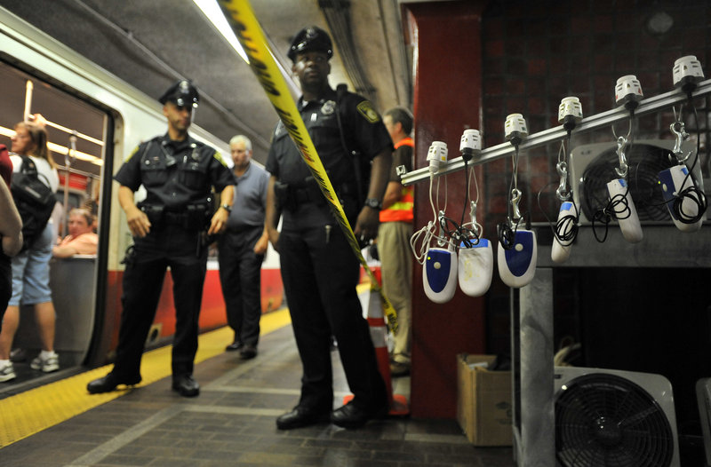 MBTA police officers and passengers look on as a machine releases gases and fluorescent particles Friday, during an exercise in Boston’s Park Street Subway station. Scientists released the gases and fluorescent particles to study how toxic chemicals and lethal biological agents could spread through the nation’s oldest subway system in a terrorist attack.