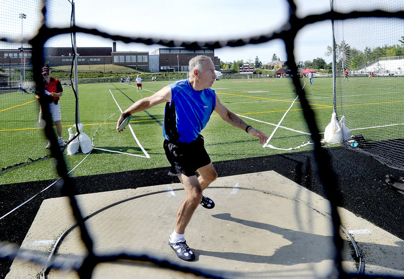 Henry DeForest, 75, of Hopkinton, Mass., unleashes the discus for a heave of 80 feet, 7 inches to finish second in his age group behind Joseph Hayes of Ocala, Fla.