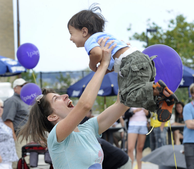 Monica Jalil and her son Remi, 2, of Washington, D.C., dance at the Portland Music and Arts Festival on Saturday.