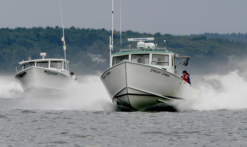 Motivation, left, and Starlight Express, right, head down the course during the Portland Lobster Boat Races.