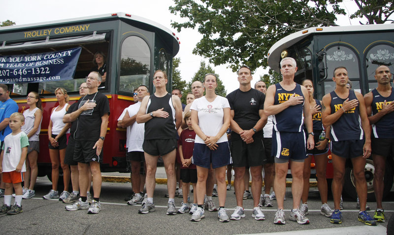 Runners listen to the national anthem Sunday before the start of the Run for the Fallen Maine from Ogunquit to Portland to honor troops who died in Iraq and Afghanistan.