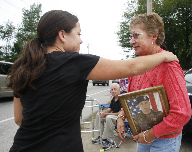 runner Lisa Randazzo of Berwick stops to introduce herself to Sarah Allard of North Berwick who holds a picture of her grandson Army Sgt. Jeremiah Holmes, with whom Randazzo graduated high school.