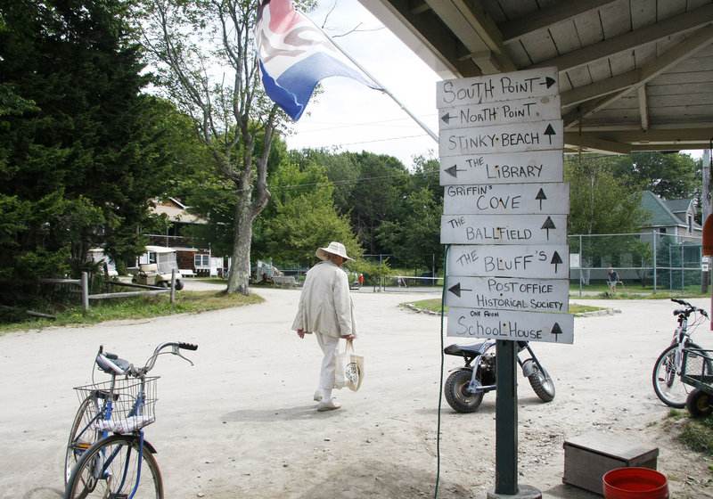 After shopping for eggs and sugar, Eva Alming, a Cliff Island summer resident since the 1930s, walks past hand-written directional signs posted outside Pearls Seaside Market. "He's the best store we've ever had," said Alming.