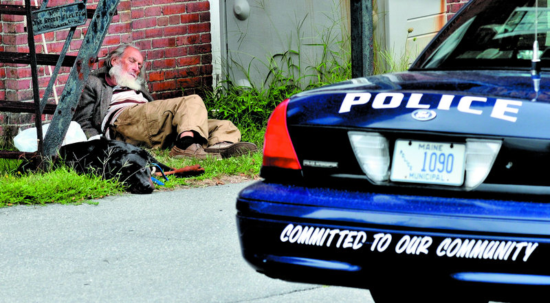 Rod Rodriquez rests with his dog behind the Skowhegan Police Department on Monday. Rodriquez was taking a break from walking at the “Nature Park, Nature Trails for the Homeless People of Somerset County,” a site located in a residential neighborhood in town.