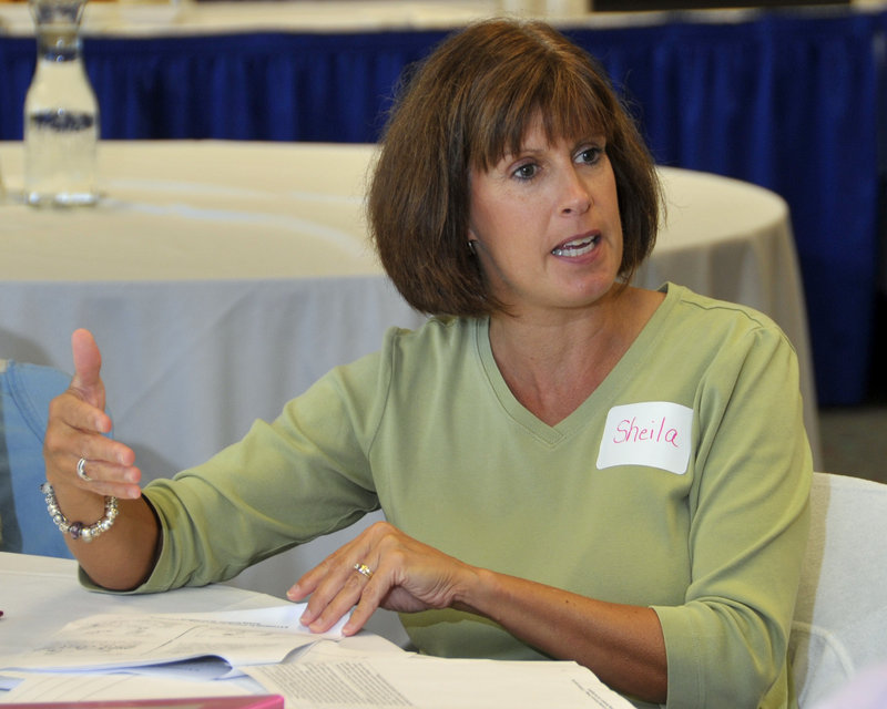 Sheila Farragher, a kindergarten teacher at Riverton Elementary, takes part in a discussion during teacher training at the Glickman Family Library in Portland. Riverton is one of several schools in Maine that have so far qualified for millions of dollars in federal aid.