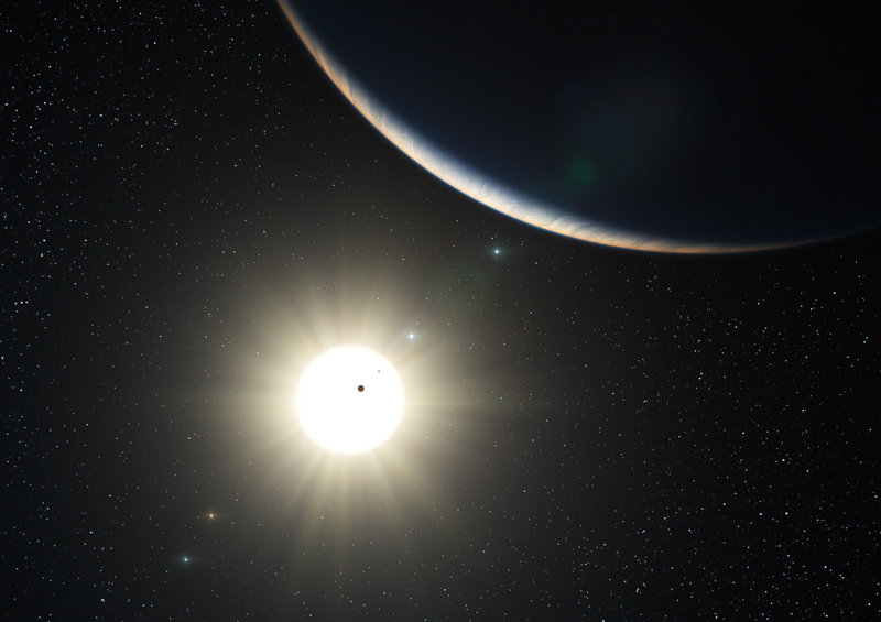 An artist’s impression shows the planetary system around the sun-like star HD 10180. Observers at La Silla, Chile, found one planet with a mass about 1.4 times that of Earth.