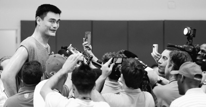 Yao Ming, the 7-foot-6 center, talks with reporters after a workout Tuesday. A stress fracture in his foot has healed and he hopes to play a full season with Houston.