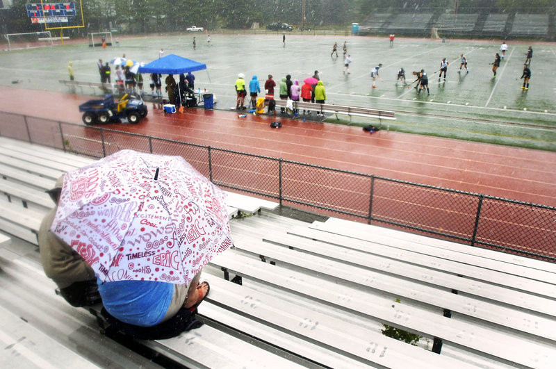 Hey, the kids are playing. And that means neither rain nor … well, rain, and lots of it. But these folks were there for field hockey and support, no matter what.