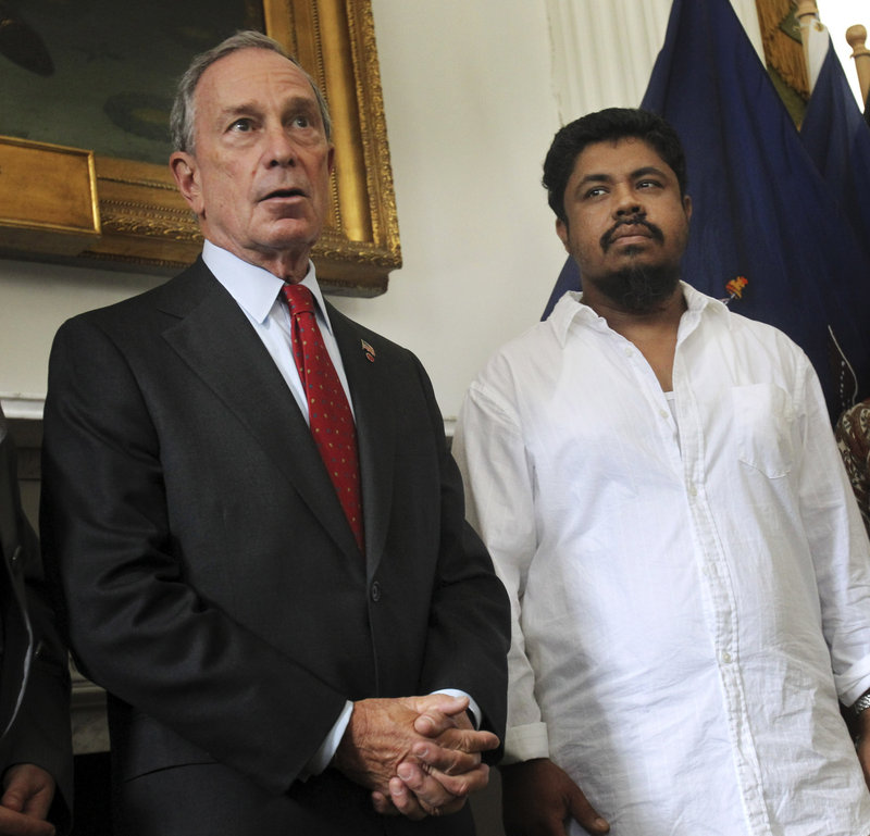 New York City Mayor Michael Bloomberg appears with taxi driver Ahmed Sharif on Thursday. Sharif, who was attacked Wednesday, said, “Of course it was for my religion.”