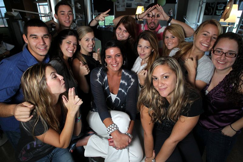 Michelle Zubizaretta, center, poses with some of her Gen-Y employees at her Zubi Adverstising in Coral Gables, Fla.