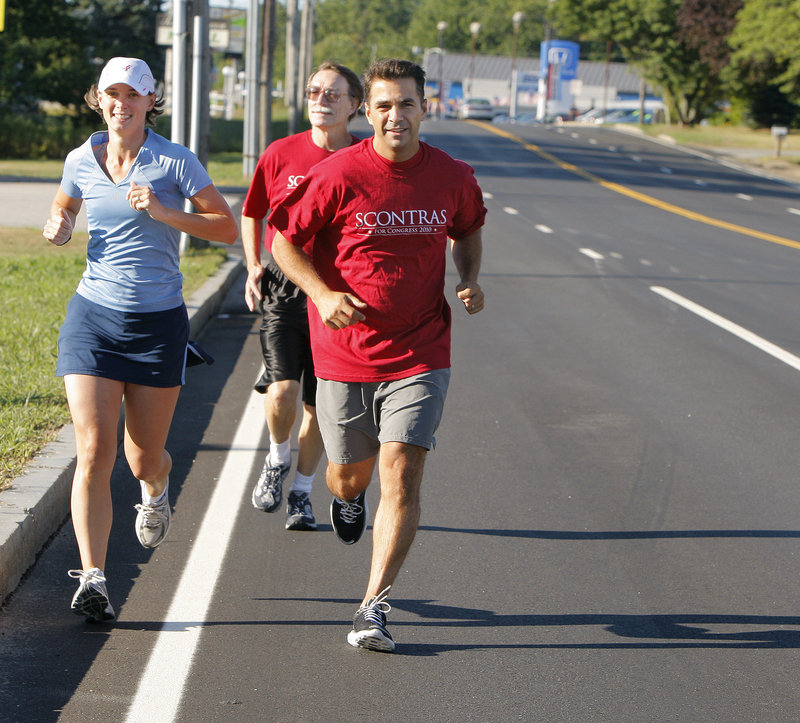 Dean Scontras, right, a Republican challenging Rep. Chellie Pingree for Maine’s 1st District House seat, jogs with Kate Norfleet, left, and Allen Lifvergren on Route 1 in Saco.
