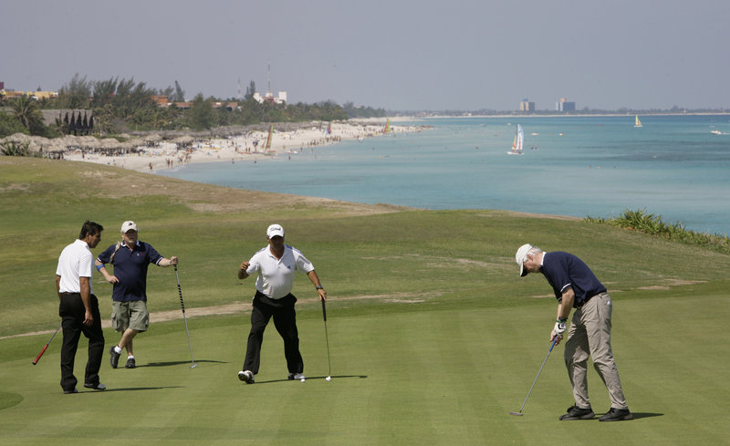 Golfers use a practice area during the Montecristo Cup Golf Tournament in Varadero, Cuba. Cuba has announced that it will allow foreign investors to lease government land for up to 99 years, potentially touching off a golf-course building boom.
