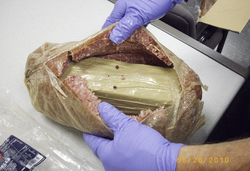 A Holyoke, Mass., police photo shows a kilogram of cocaine hidden in a hollowed-out chunk of bologna.