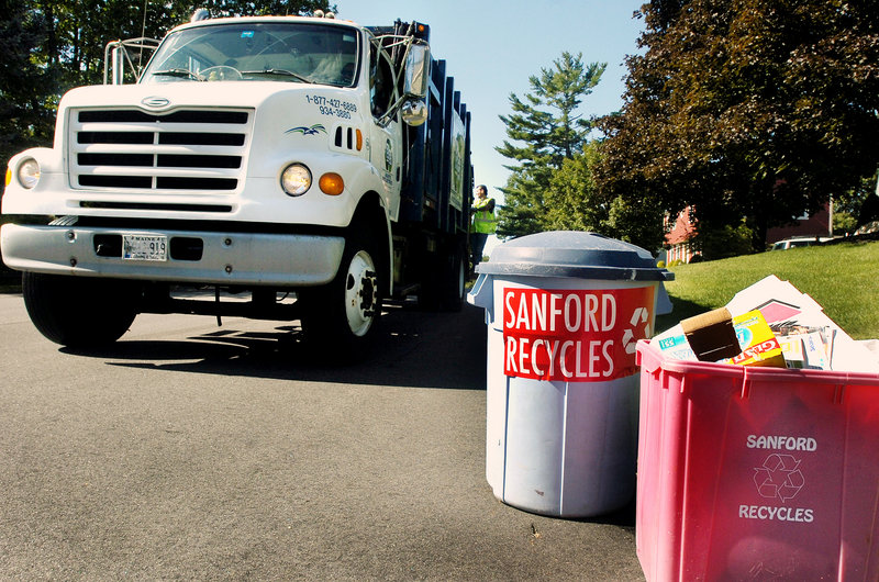 Sanford Public Works Department workers pick up items to recycle. Recycling has increased since the town instituted a pay-per-bag system for trash disposal.