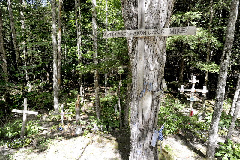 Memorials to car accident victims stand along a section of Route 11 in Casco where nine people have died in accidents in the last 10 years. Across the road from the memorials, a car driven by Nicholas Sparrow struck a tree early Sunday, killing two of his passengers.