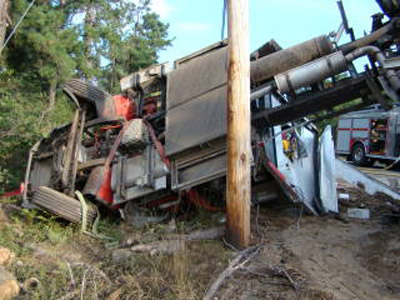 The pumper-tanker carrying 1,800 gallons of water hit a soft shoulder and rolled over on Newfields Road.