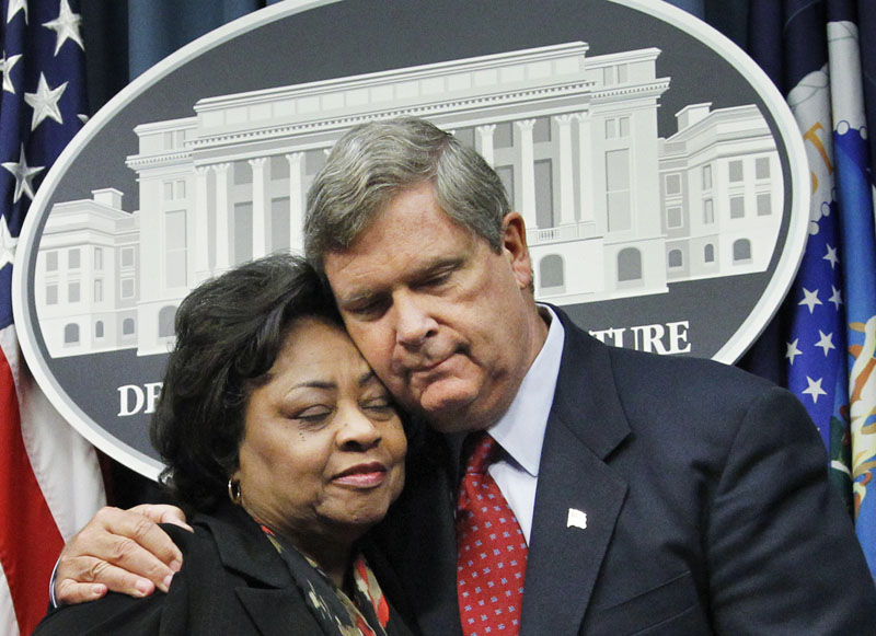 Department of Agriculture Secretary Tom Vilsack puts his arm around former Agriculture Department official Shirley Sherrod as they conclude a news conference in Washington today.