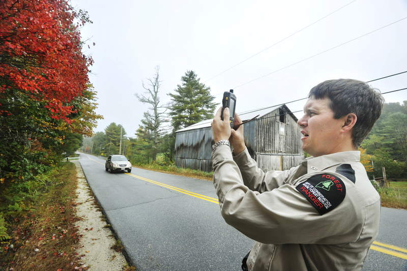 Art Lavoie, a forest ranger with the Maine Forest Service, files a foliage report each week that appears on the state’s foliage website, www.mainefoliage.com. Here, Lavoie uses his PDA to photograph examples of the foliage on Mayall Road in Gray.