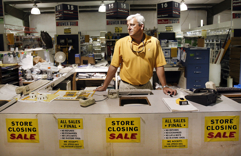 Surrounded by “for sale” signs, co-owner Bryan Neal contemplates what he might do with the building and property after Depot Building Supply in Lexington, S.C., shuts down this month. The store is closing after three decades, with Neal and his father, Tom, selling off the last of their inventory.