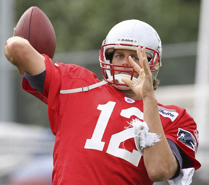 Patriots quarterback Tom Brady works a passing drill during practice at the team's facility in Foxborough, Mass., this afternoon.
