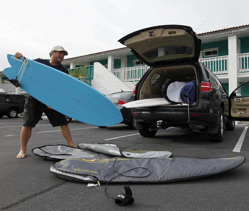 Scott Reese, of Asheville, N.C., packs his surfboards up as he prepares to evacuate for Hurricane Earl, as it heads toward the eastern coast, in Atlantic Beach, N.C., Thursday, Sept. 2, 2010. (AP Photo/Chuck Burton)