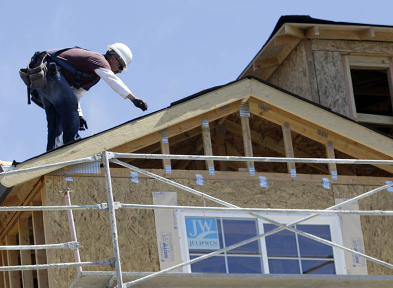 In this Sept. 16, 2010 photo, a roofer works on a Toll Brothers homes under construction in Sunnyvale, Calif. Housing construction surges 10.5 percent in August, as applications for building permits rise.(AP Photo/Paul Sakuma)