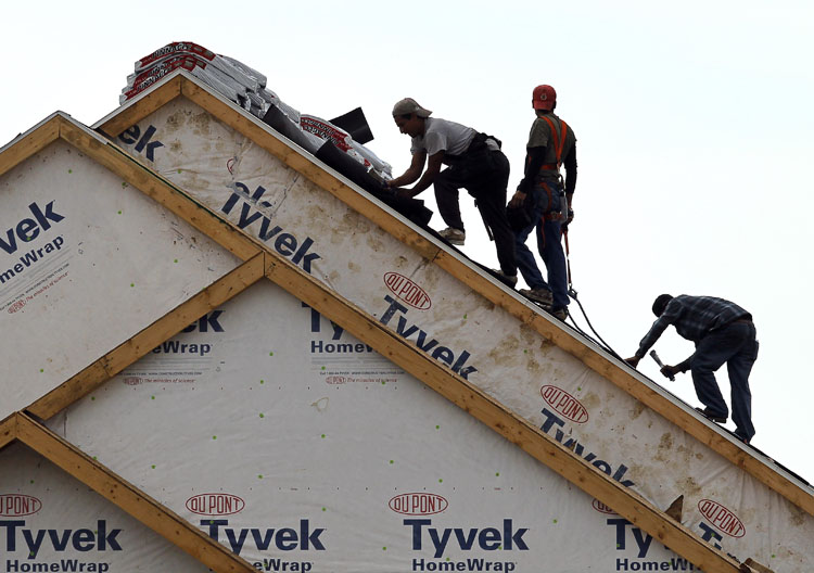 Workers install a roof at a new home construction site in West Des Moines, Iowa, recently. Sales of new homes had their second-worst month on record in August, signaling that the housing market remains a severe weak spot for the economy.