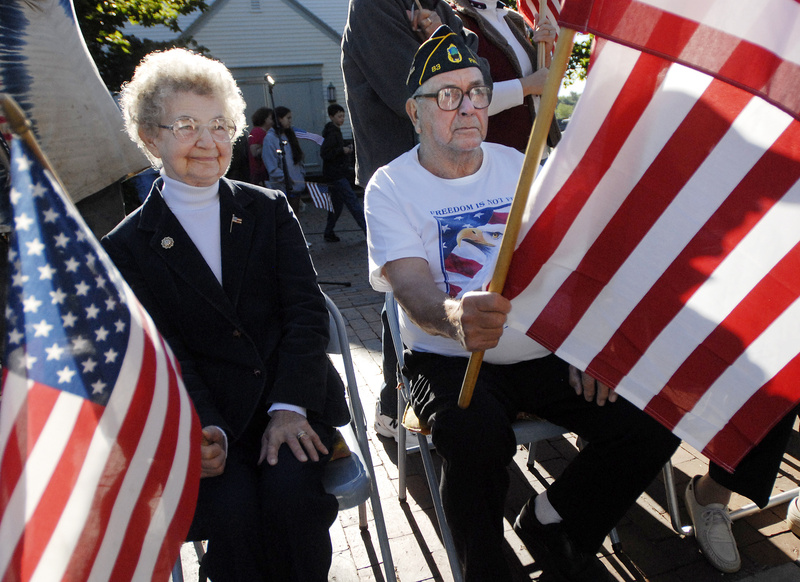 Josephine and Roland Goss of Pownal wave flags along Main St. in Freeport along with the Freeport Flag Ladies and others who joined them for their 9th annual 9-11 tribute today. Roland Goss is a veteran and commander of American Legion Post 83.