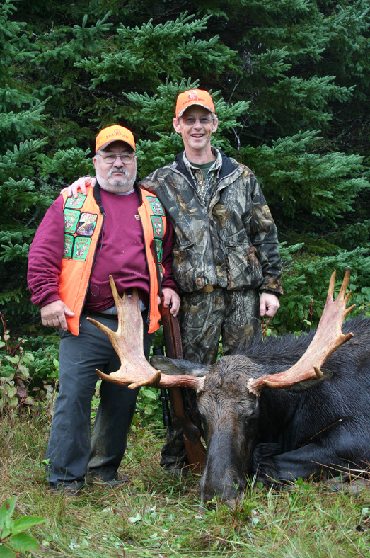 Francis Dumas, a veteran from Augusta, left, with Joe Boyd, one of the volunteer guides in the September special hunt, and the moose Dumas bagged.