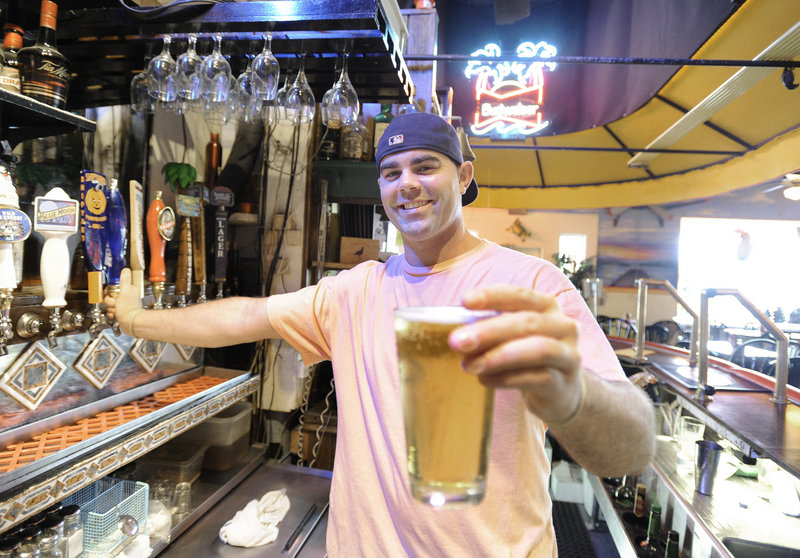 Bartender Nick Duffy serves up a draft at Rick's Cafe in Naples.