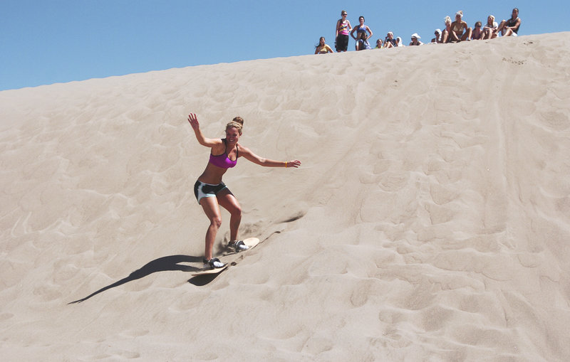 Alyssa Smith, 19, of Longmont, Colo., sandboards the dunes.