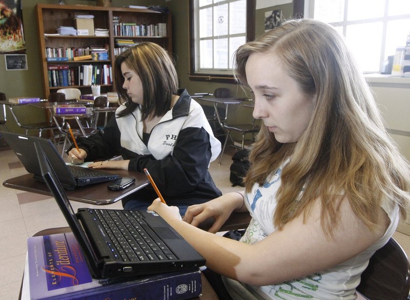 Portland High School students Kristina Glanville, right, and Emily St. Pierre work on the SAT Question of the Day during their freshman homeroom class last spring. Such tests measure overall progress only if enough students take them, a reader says.