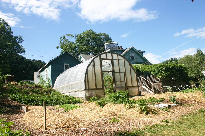 The greenhouse, strawberry patch, grape arbor and some of the annual beds sit behind the Fernandes-Whitten house.