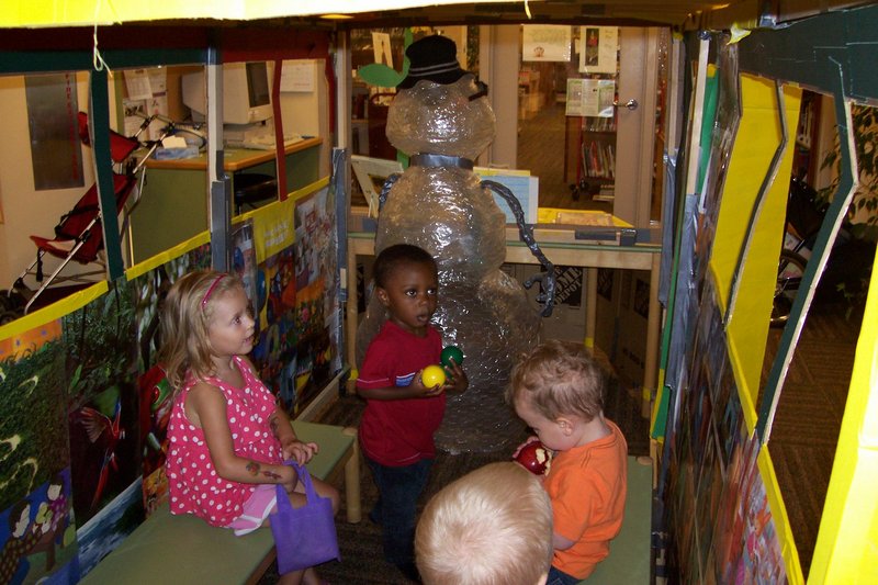 Youngsters enjoy the children-sized school bus that is part of the program at Walker Memorial Library in Westbrook. The bus driver is Dr. Snow, a snowman made by a teen assistant.
