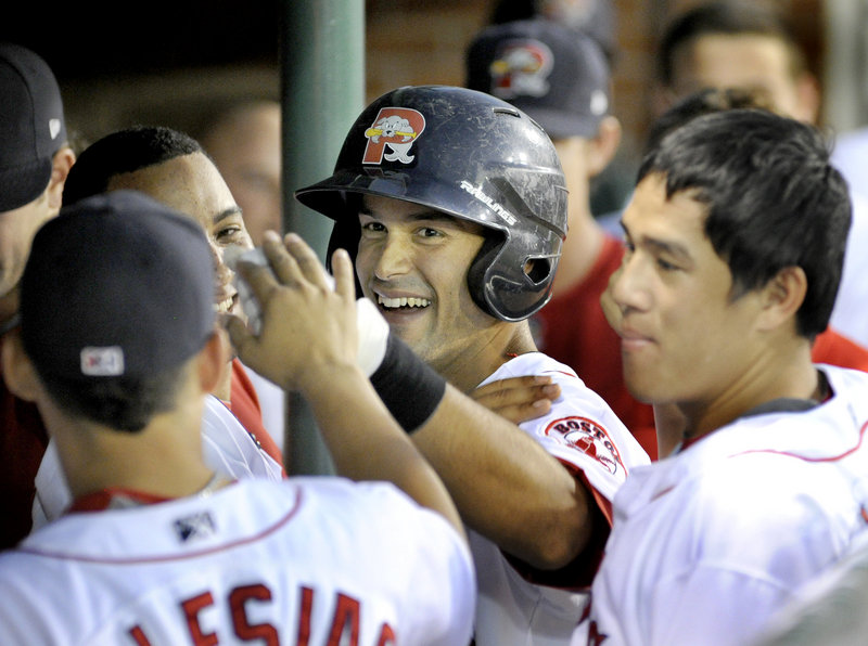 Will Vazquez of the Portland Sea Dogs is welcomed by teammates Tuesday night after hitting a home run during a 6-0 victory against the Binghamton Mets at Hadlock Field.